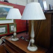 A pair of cream painted table lamp with