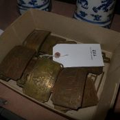 A collection of bronze belt buckles