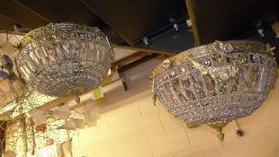 A pair of cut glass and brass light shades
