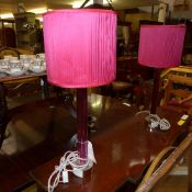 A pair of red stem glass table lamps and matching shades