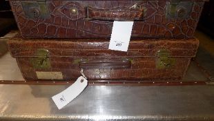 A vintage crocodile leather suitcase