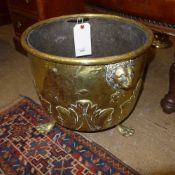 A C19th brass log basket on claw and bal
