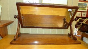 A Victorian mahogany swing frame dressing mirror with bevelled plate