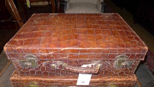 A vintage crocodile leather suitcase
