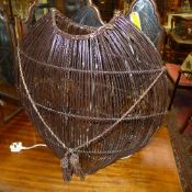 A contemporary ovoid form basket weave lamp