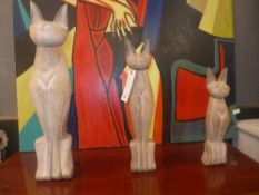 Three carved wooden model cats