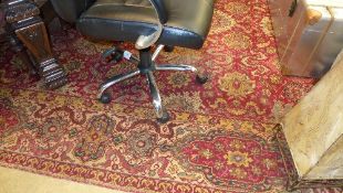 A Persian type carpet the red ground with allover stylized motifs in single border