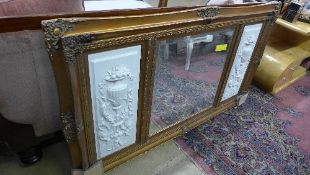A gilted wall hanging mirror with marble plaques