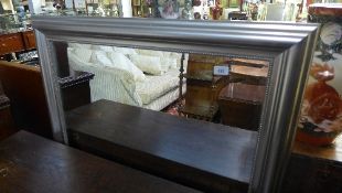A wall mirror the bevelled plate in silvered frame