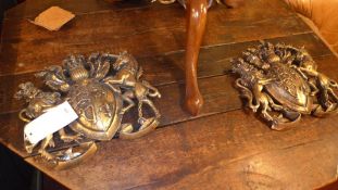 A pair of coat of arms with distressed gold finish