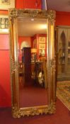 A pier mirror of large size the rectangular plate within swept gilt frame