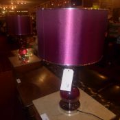 A pair of red glass modernist table lamps of globular form with shades