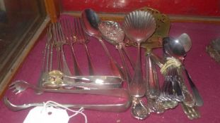 A collection of silver plated flatware