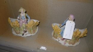 A pair of Continental porcelain figure groups of children in a corn field