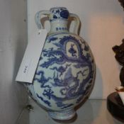 A Chinese blue and white moon flask decorated with dragons