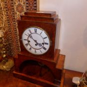 An Art Deco burr walnut mantel clock of unusual architectural form the enamelled dial with Roman