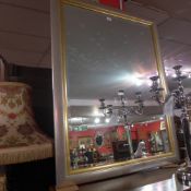 A contemporary silver an parcel gilt rectangular wall mirror with a bevelled plate
