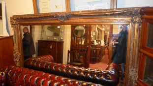 A wall mirror of large size the rectangular bevelled plate within ornate frame