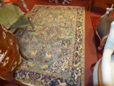 A Persian carpet the sapphire blue field decorated with varied animal motifs within a triple border