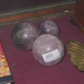 A set of three purple crystal balls of graduating size