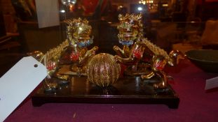 A model of filigree style Dogs of Fo on a ball on wooden base