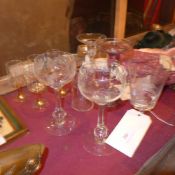 An etched rummer decorated with a leaping stag together with a collection of other drinking glasses