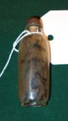 A Chinese reverse painted snuff bottle decorated with landscapes