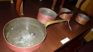 Three copper saucepans and a preserve pan