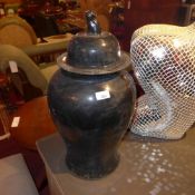 A pair of Chinese lidded temple jars with black glaze