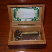 A Swiss birdeye maple musical box (one foot missing)