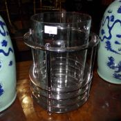 A chrome and glass cylindrical storm lantern of large size