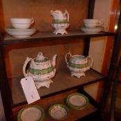 A C19th part tea set decorated with a green border and gilding including a teapot, sucrier ( no