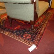 A Persian Abadell rug with central pendant medallion on a terracotta field in geometric border
