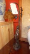 An Art Nouveau style faux bronze table lamp in the form of a maiden