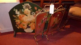 Two brass fire screens with beveled mirror inserts together with a similar all decorated with