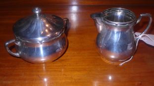 A silver plated sugar bowl and cream jug