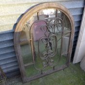 An arched gated garden wall mirror