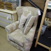 A wingback armchair upholstered in paisley motif fabric