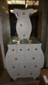 A white painted multi drawer chest and matching bedside cabinet