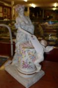 A Meissen style figure group of a lady and a cherub playing a drum