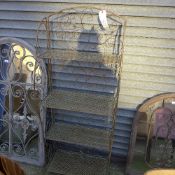 A wrought iron four tier floral garden rack