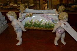 A Dresden style centre piece with cherub supports