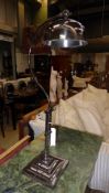 A chromium floor standing adjustable lamp