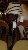 A contemporary standard lamp with faux zebra hide shade