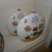 A pair of 'Moon Flask' vases with butterfly and floral decoration