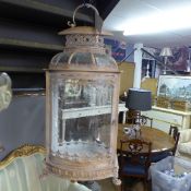 A cream painted wrought iron and glass hanging lantern