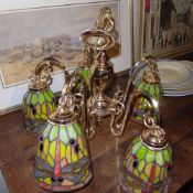 A pair of hanging chandeliers with Tiffany style stained glass shades