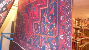 A fine North East Persian Meshad Belouch rug 225 x 120 cm central pole medallion on a rouge field