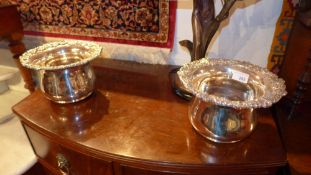 A pair of silver plated wine coasters with grapewine detail in relief