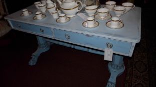 A William IV and later painted distressed finish writing table fitted two drawers raised on